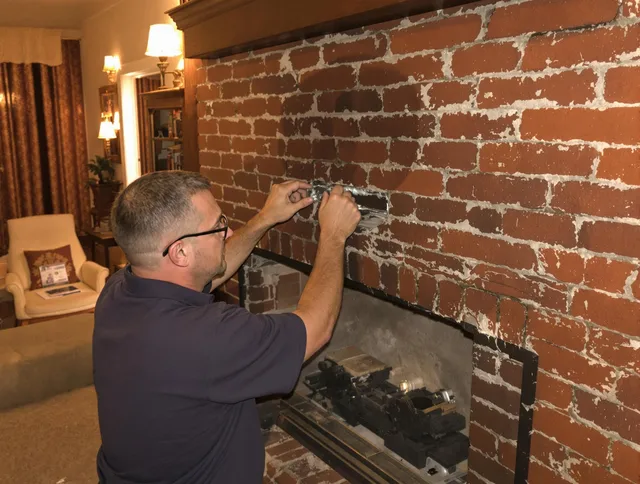 Boca Raton Chimney Sweep expert fixing a fireplace in Boca Raton, FL